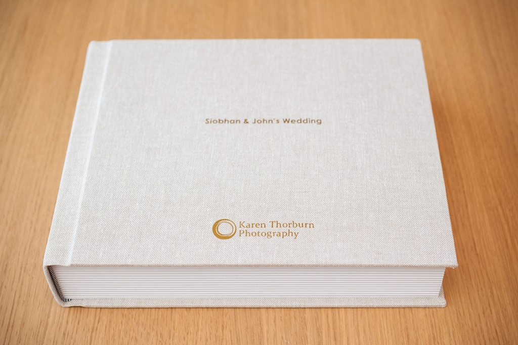 Rectangular traditional wedding album with an oatmeal linen cover and gold foil embossing