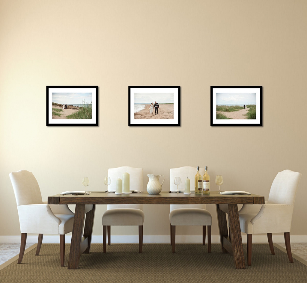 Contemporary dining room with three framed wedding pictures on the wall, showing a bride and groom walking on a beach